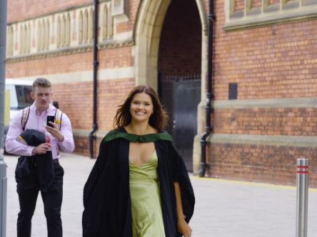 Sam looks on (or checks his messages).